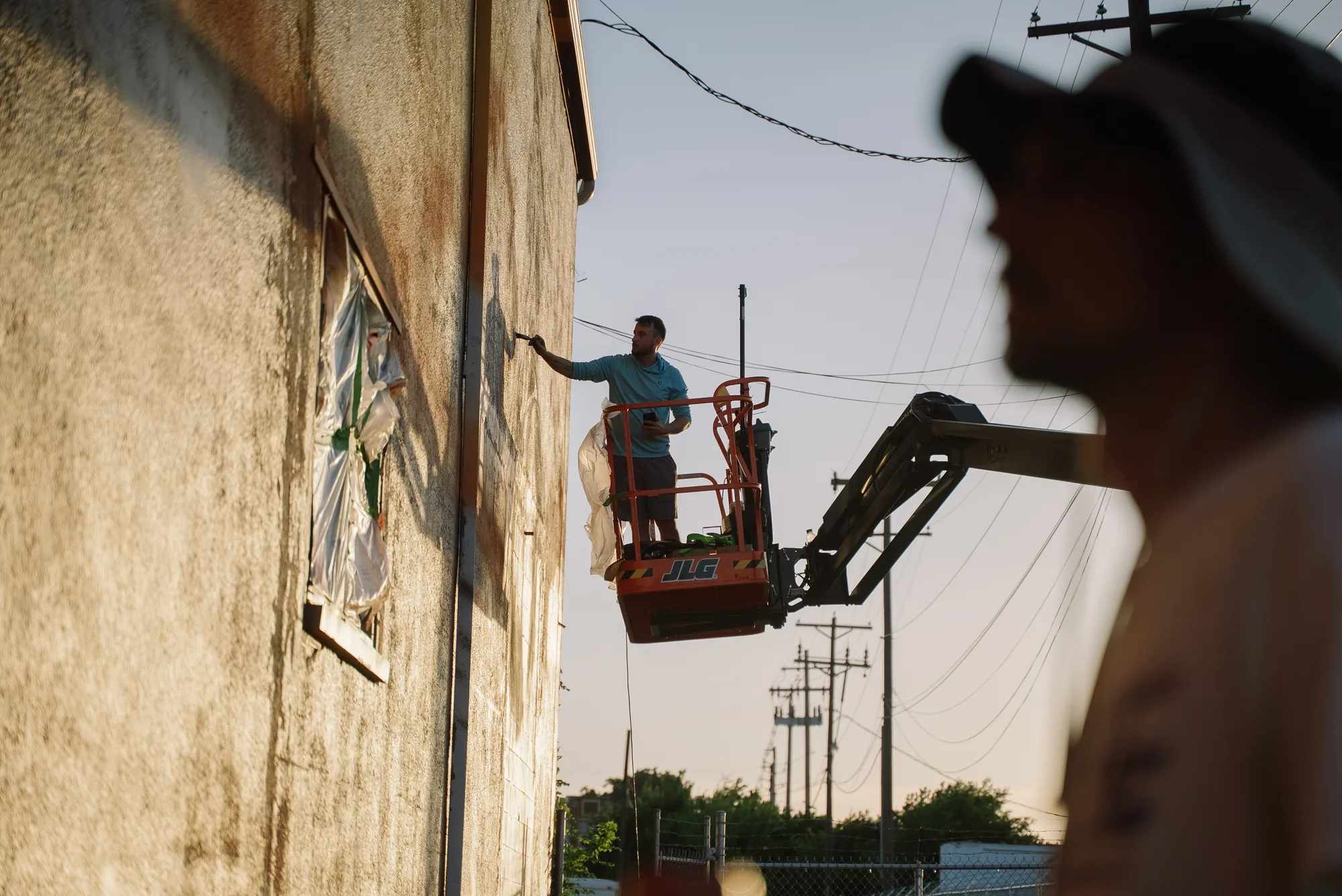 Pezer97 painting the Frontier Spirit mural in Abilene, Texas