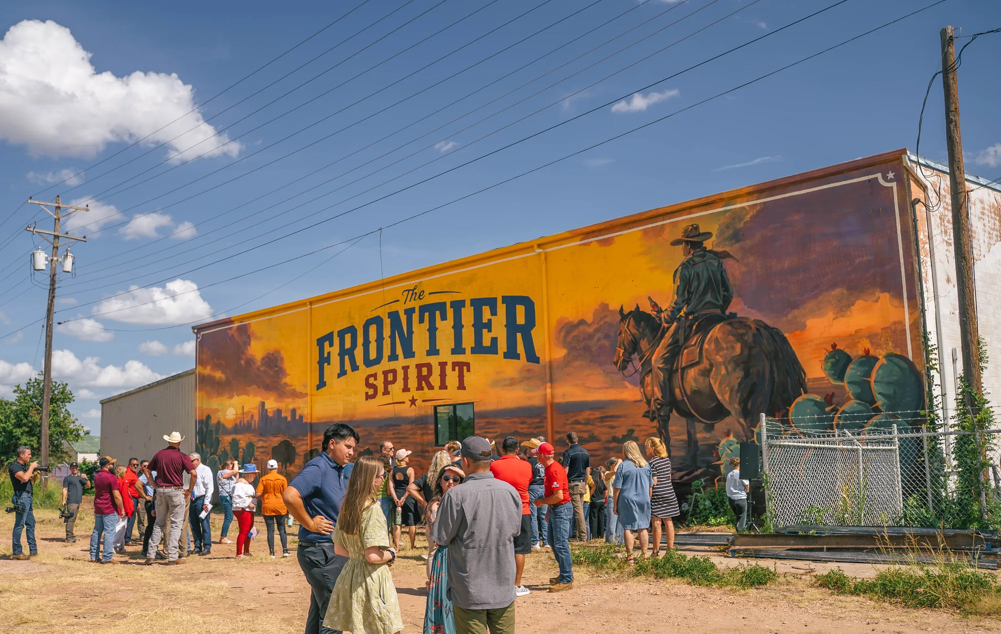 Community gathered at the unveiling of the Frontier Spirit Coca-Cola mural in Abilene, Texas