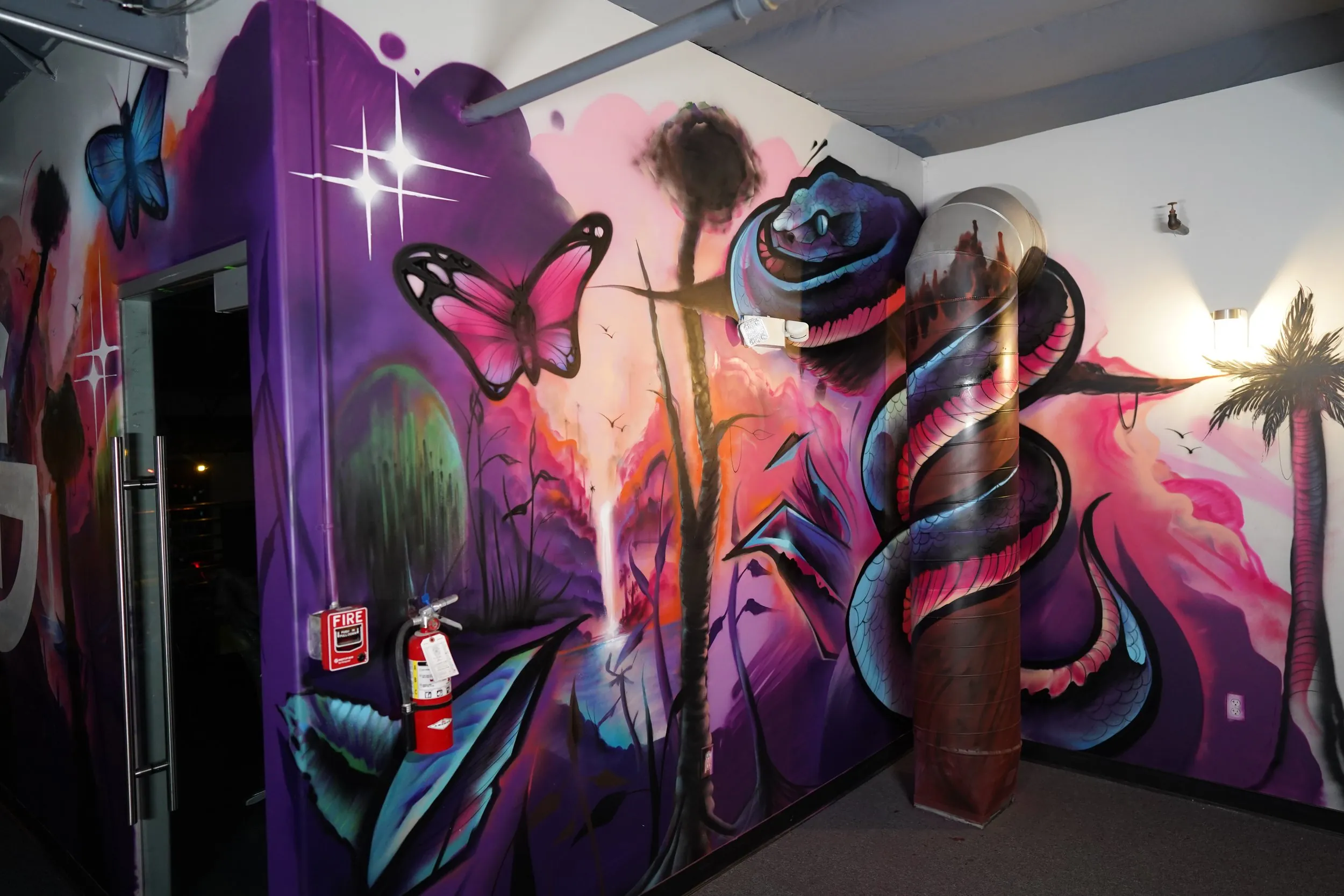Bold jungle-themed interior mural with tigers and tropical plants painted for The Gym Southern California by Pezer97 2024