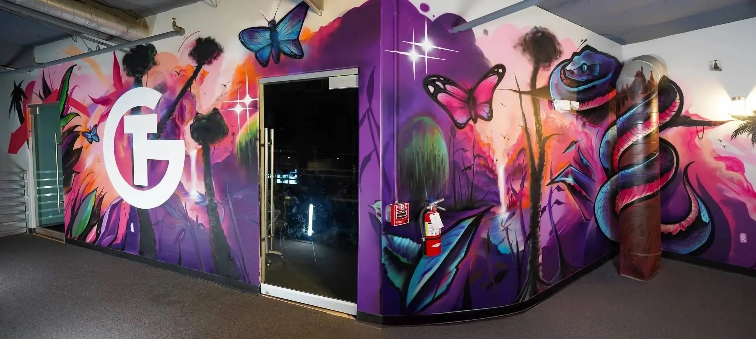 Bold jungle-themed interior mural with tigers and tropical plants painted for The Gym Southern California by Pezer97 2024